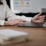 a-person-wearing-white-long-sleeves-typing-on-a-laptop