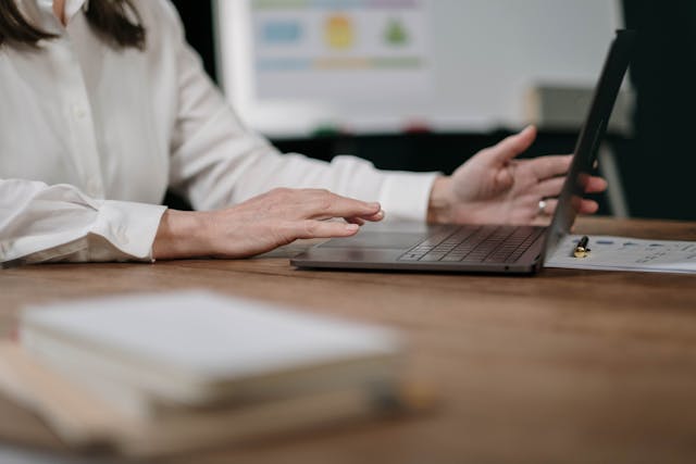 a-person-wearing-white-long-sleeves-typing-on-a-laptop