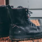pair-of-black-lace-up-boots-on-area-rug-